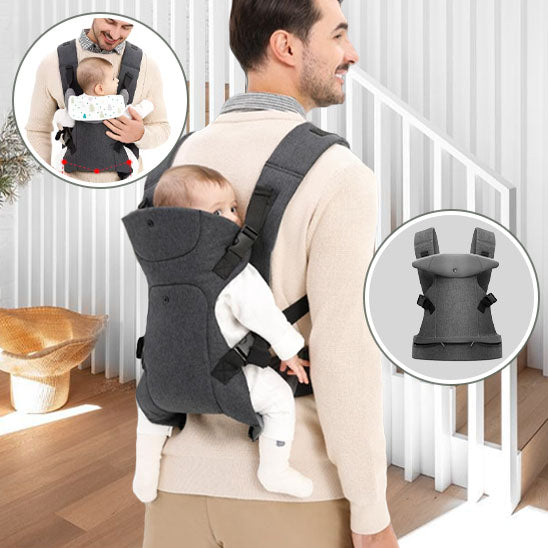 papa souriant portant son bébé au dos dans son porte bebe